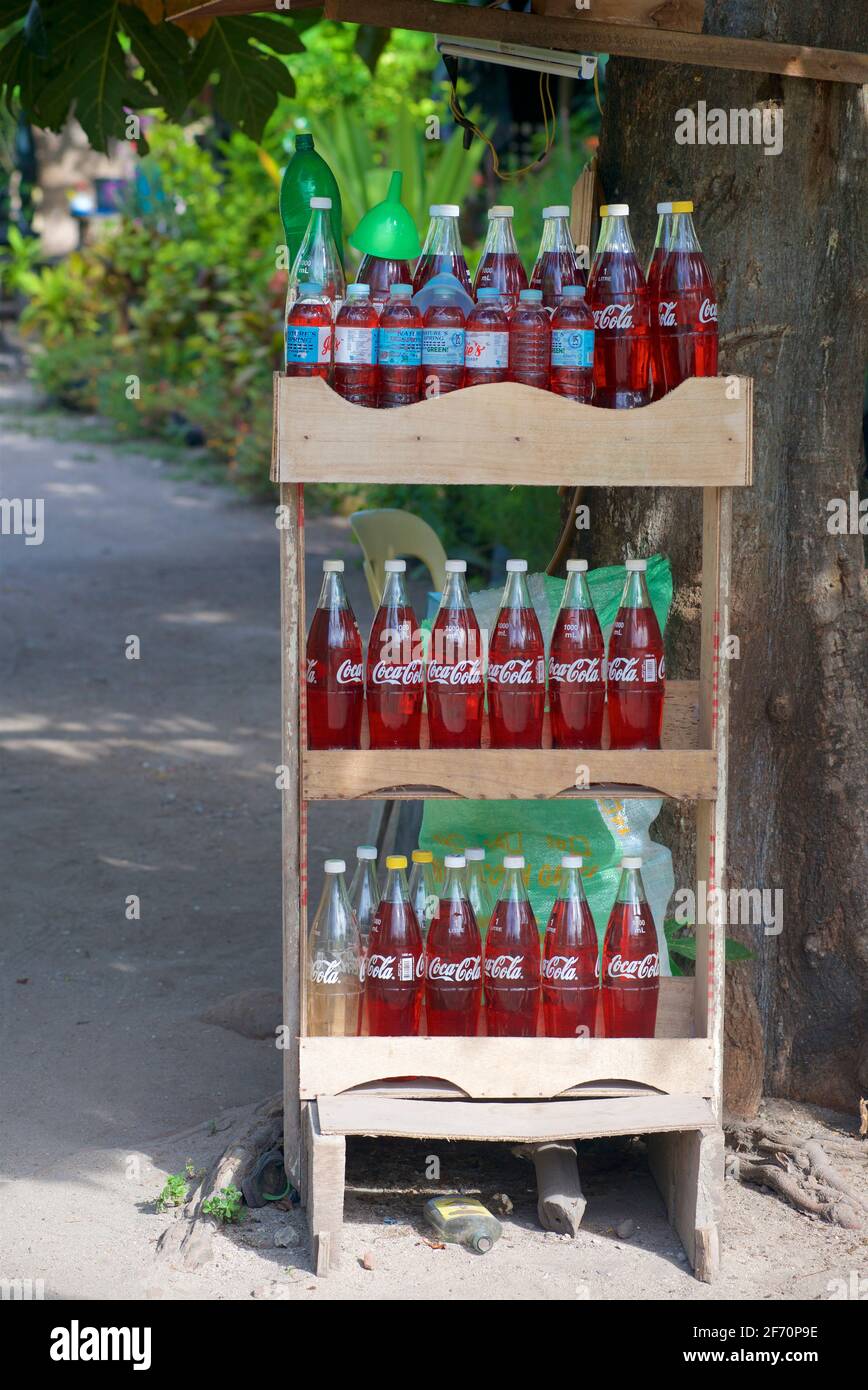 Gasoline for sale in glass soft drink bottles. Roadside petrol store. Malapascua island