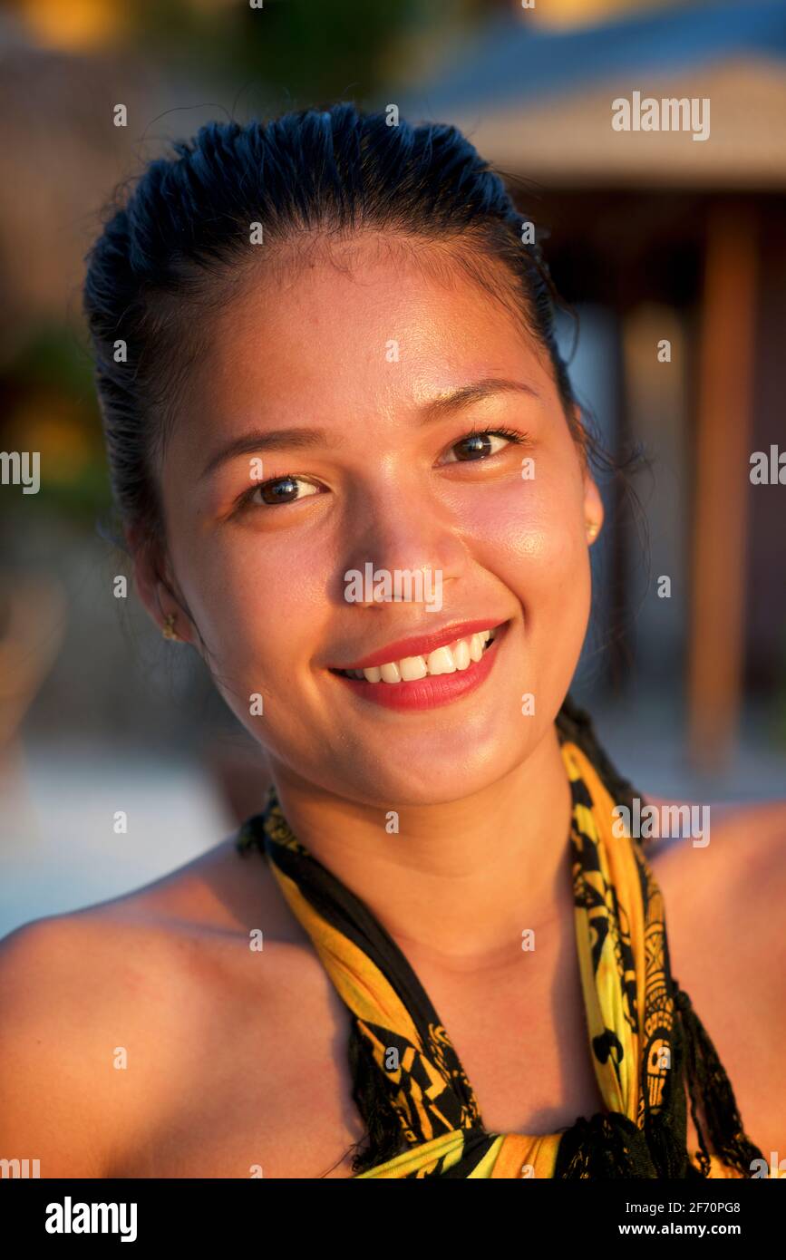 Group portrait of three, young. attractive Filipinas working at a beachside restaurant in Logon, Malapascua Island, Cebu, Philippines. Stock Photo