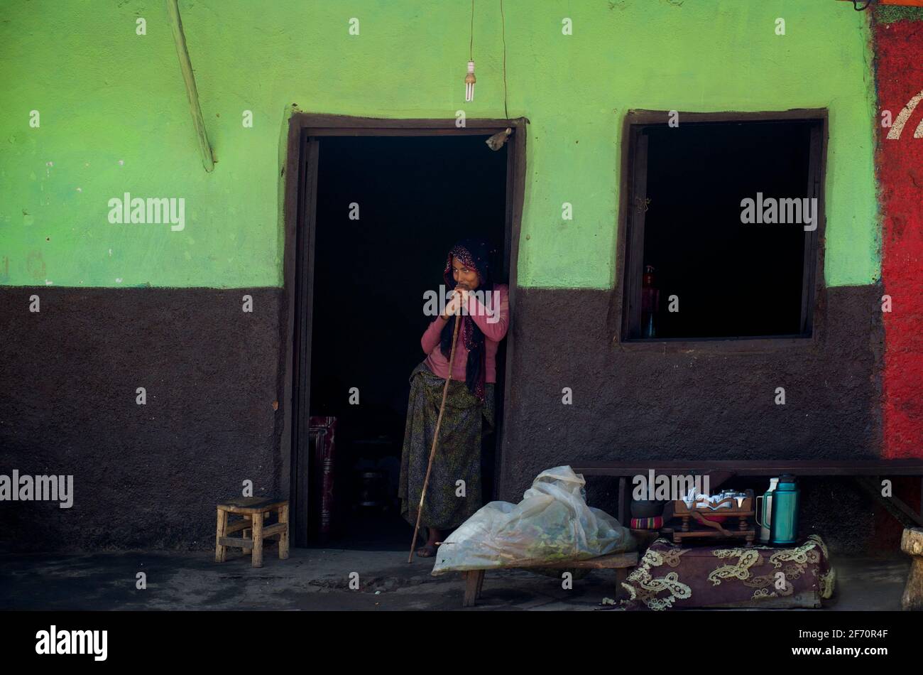 Ethiopian woman, in a shop doorwa, Kulubi, Oromia Region, Ethiopia Stock Photo