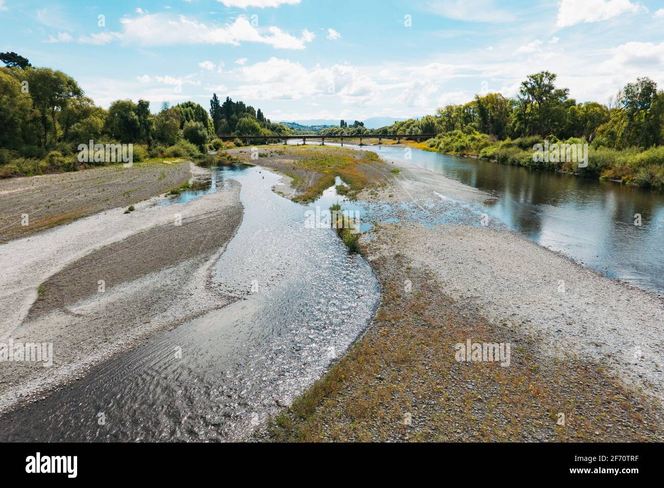 The Tukituki River flowing through the town of Waipukurau, New Zealand. A railway bridge can be