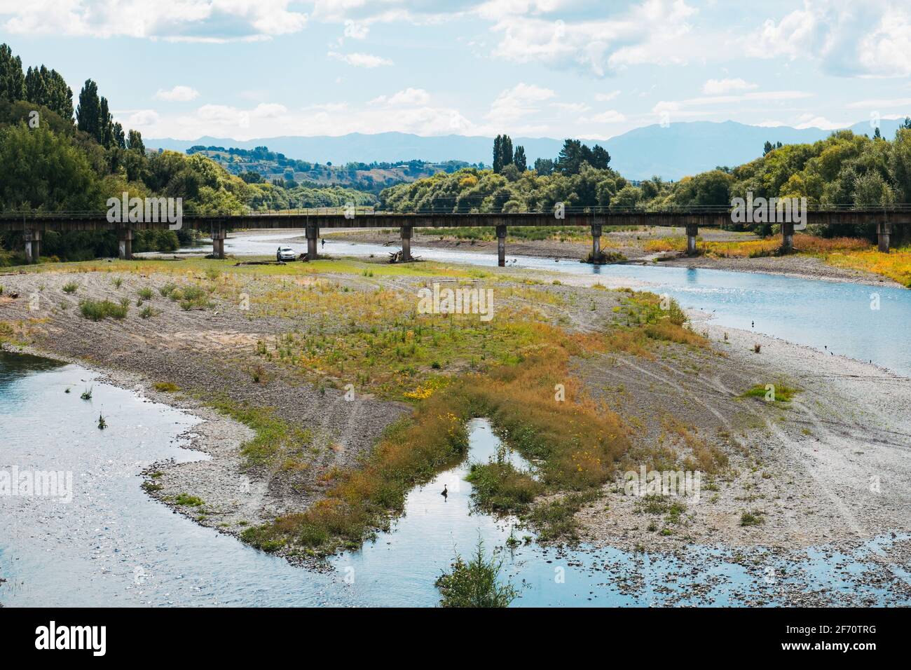 The Tukituki River flowing through the town of Waipukurau, New Zealand. A railway bridge can be