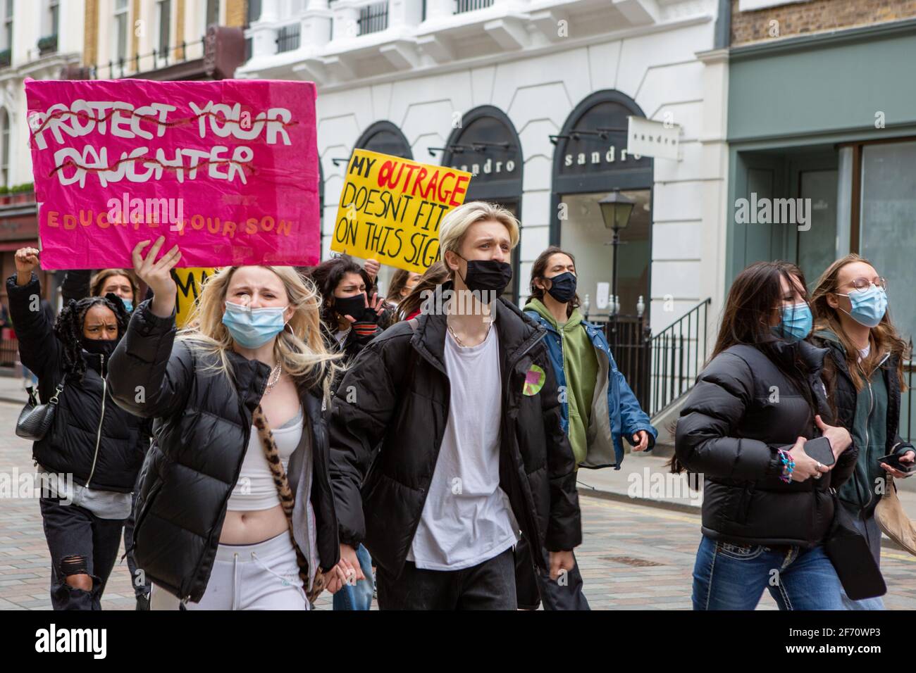 A protester marching with a placard saying, protect your daughter, during the demonstration.A Month after kidnap and murder of 33-year-old Sarah Everard, women's rights protesters marched in central London chanting slogans and protested what they said had been a lack of action by government and police services. Sarah Everard disappeared on March 3rd and her body was found on March 12th. Stock Photo