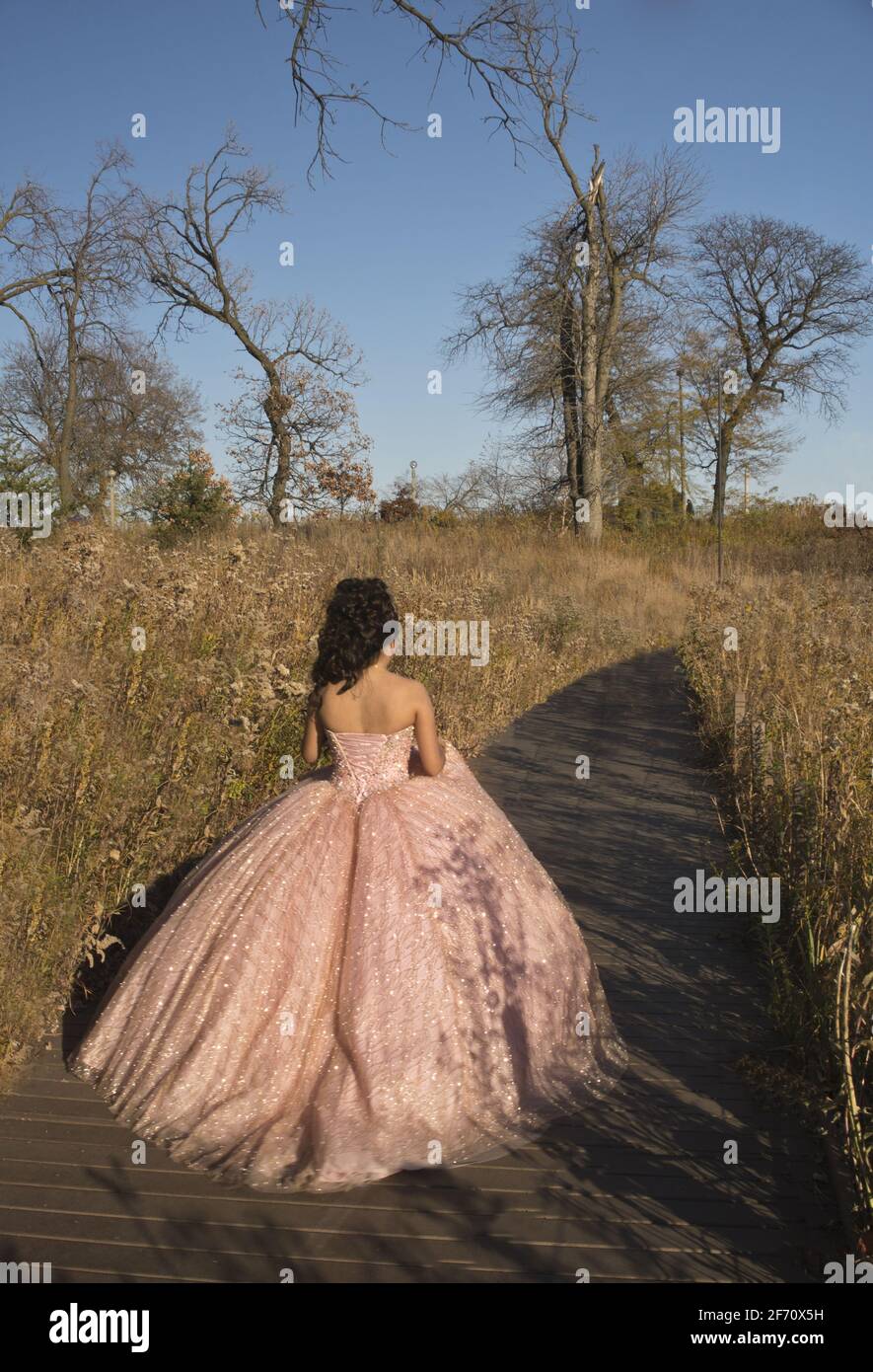 15 year old teen in Quinceanera dress along Lincoln Park Zoo's South Pond, Lincoln Park, Chicago, Illinois. Stock Photo