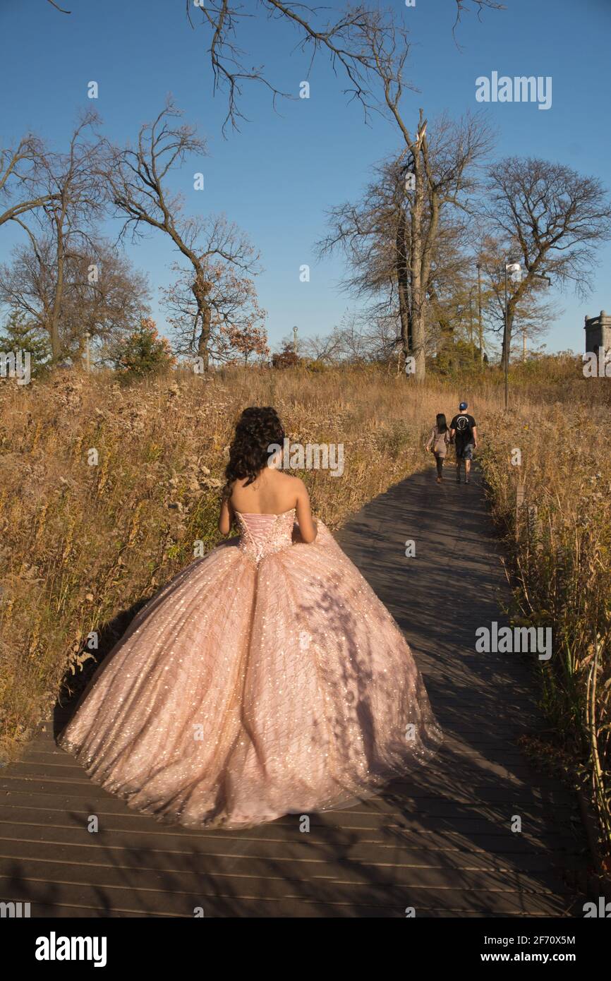 15 year old teen in Quinceanera dress along Lincoln Park Zoo's South Pond, Lincoln Park, Chicago, Illinois. Stock Photo