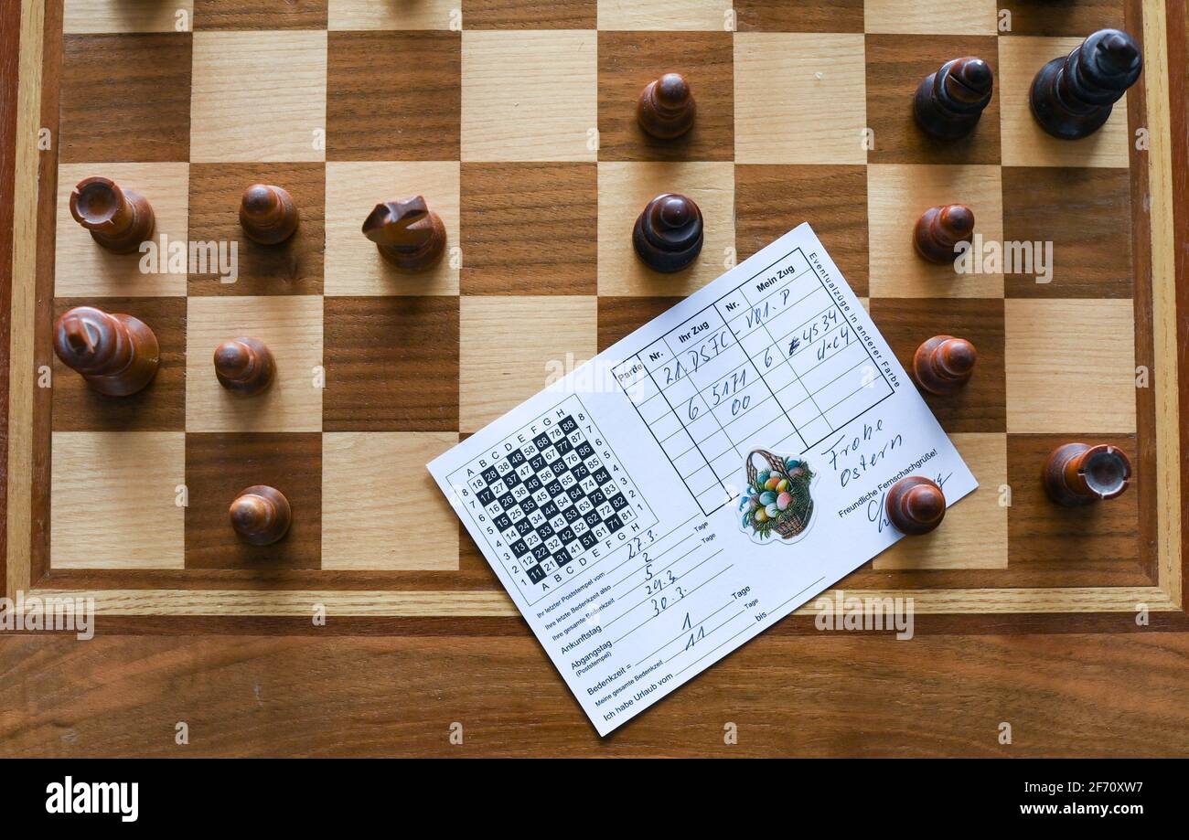 Berlin, Germany. 01st Apr, 2021. In the apartment of chess player  Heiermann, who plays correspondence chess by mail, there is a postcard on a  chess board with the chess pieces, which transmits