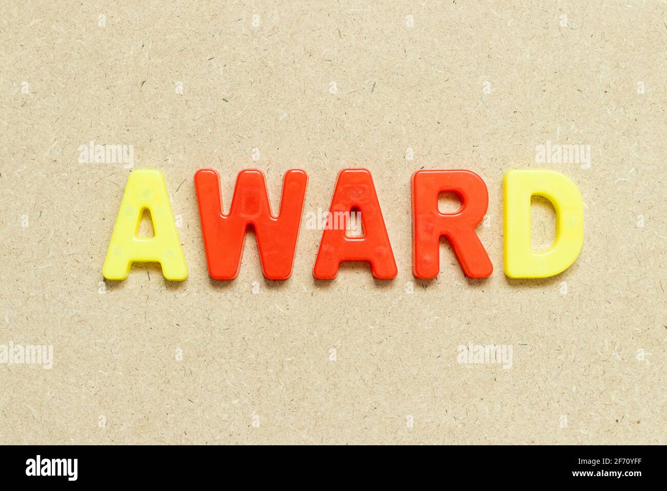 Color alphabet letter with word award on wood background Stock Photo