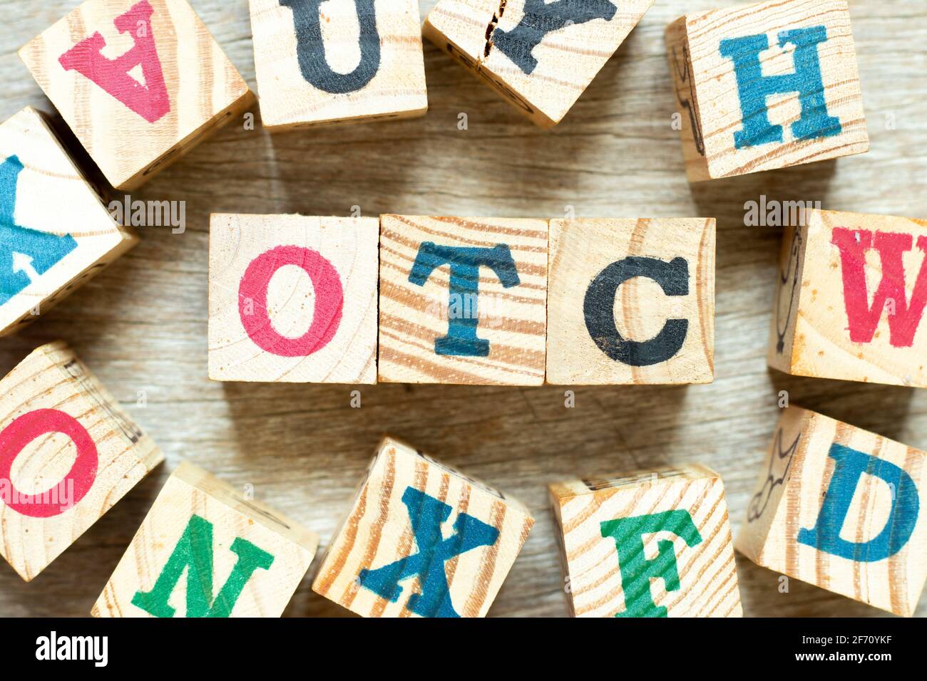 Alphabet letter block in word OTC (Abbreviation of over the counter) with another on wood background Stock Photo