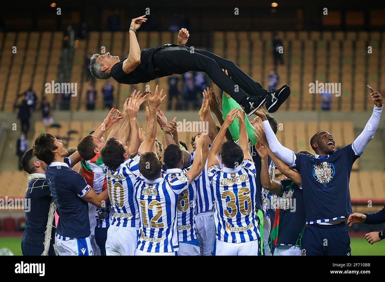 Seville, Spain. 3rd Apr, 2021. Players of Real Sociedad celebrate the victory by throwing head coach Imanol Alguacil after the Spanish King's Cup final match between Athletic Club Bilbao and Real Sociedad in Seville, Spain, on April 3, 2021. The game is the rescheduled final of the 2019-2020 competition which was originally postponed due to the coronavirus pandemic. Credit: Pablo Morano/Xinhua/Alamy Live News Stock Photo
