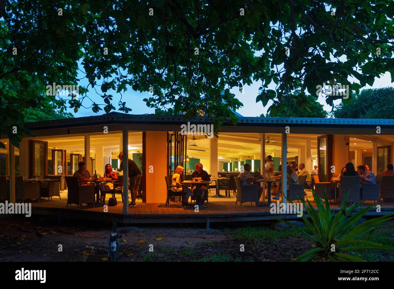 Illuminated restaurant in the evening at Heron Island Resort, Southern Great Barrier Reef, Queensland, QLD, Australia Stock Photo