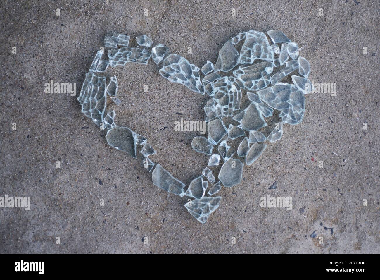 Broken love concept. Cracked heart. Heart made from glass. Heart without piece. Stock Photo