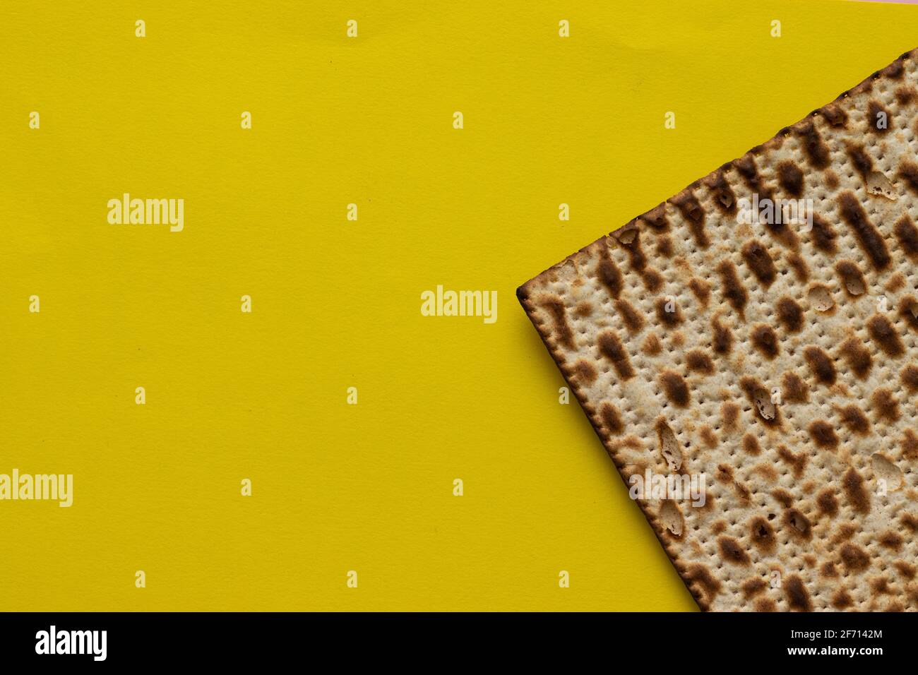 A close-up of a matzah- bread for the Jewish Passover, on a yellow background Stock Photo