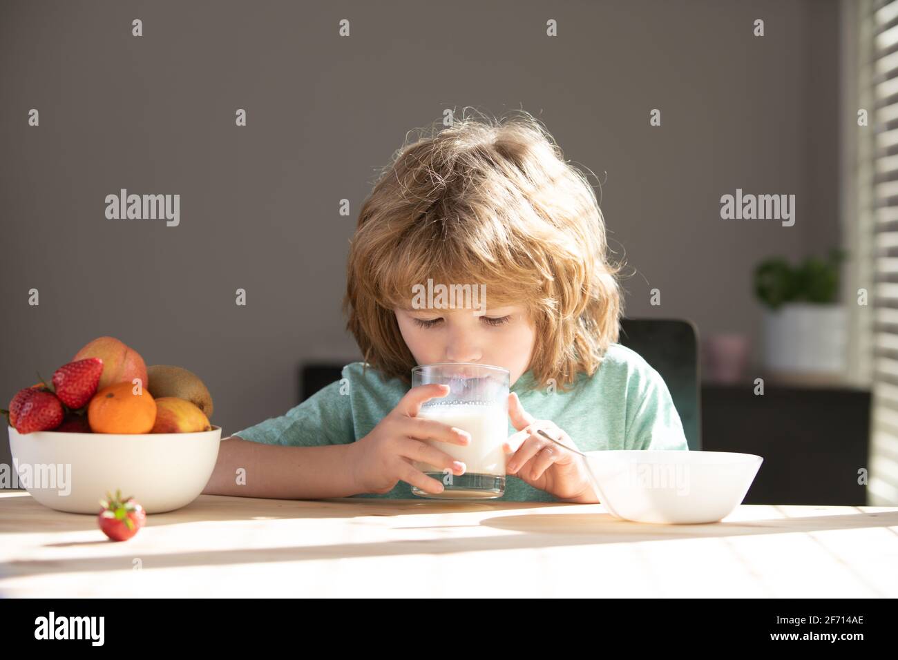 Kid drinking milk. Child eating healthy food. Stock Photo