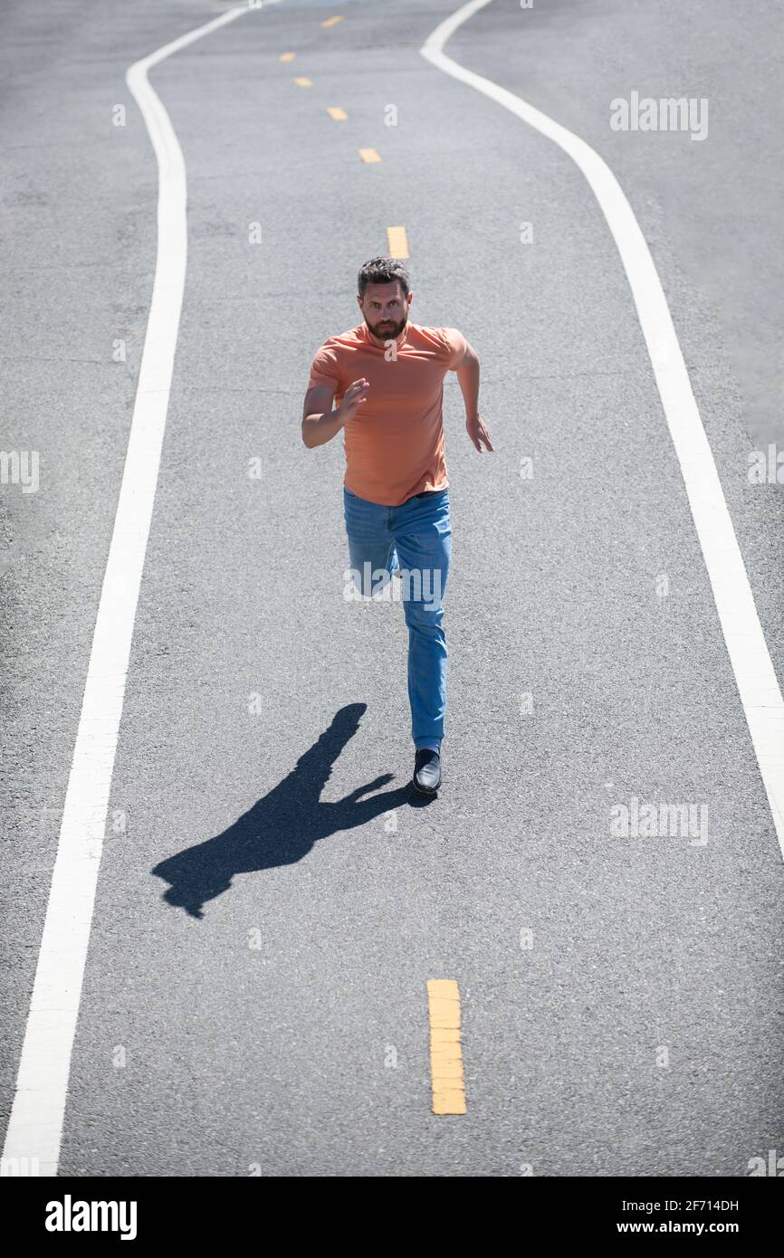 Top view runner at road. Man running on country road, sport motivation