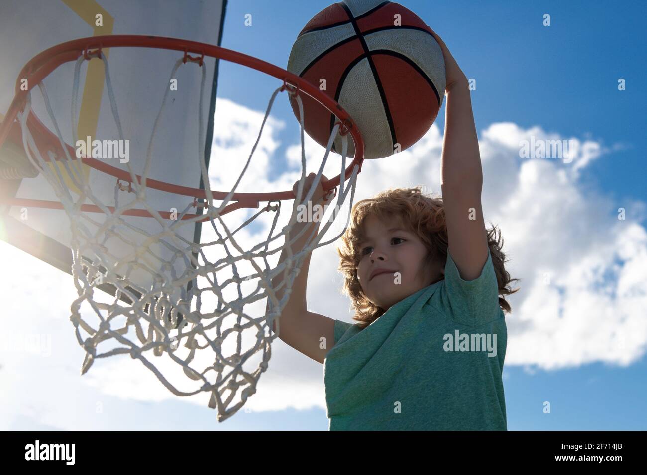 Healthy children lifestyle. Closeup face of kid basketball player making  slam dunk Stock Photo - Alamy