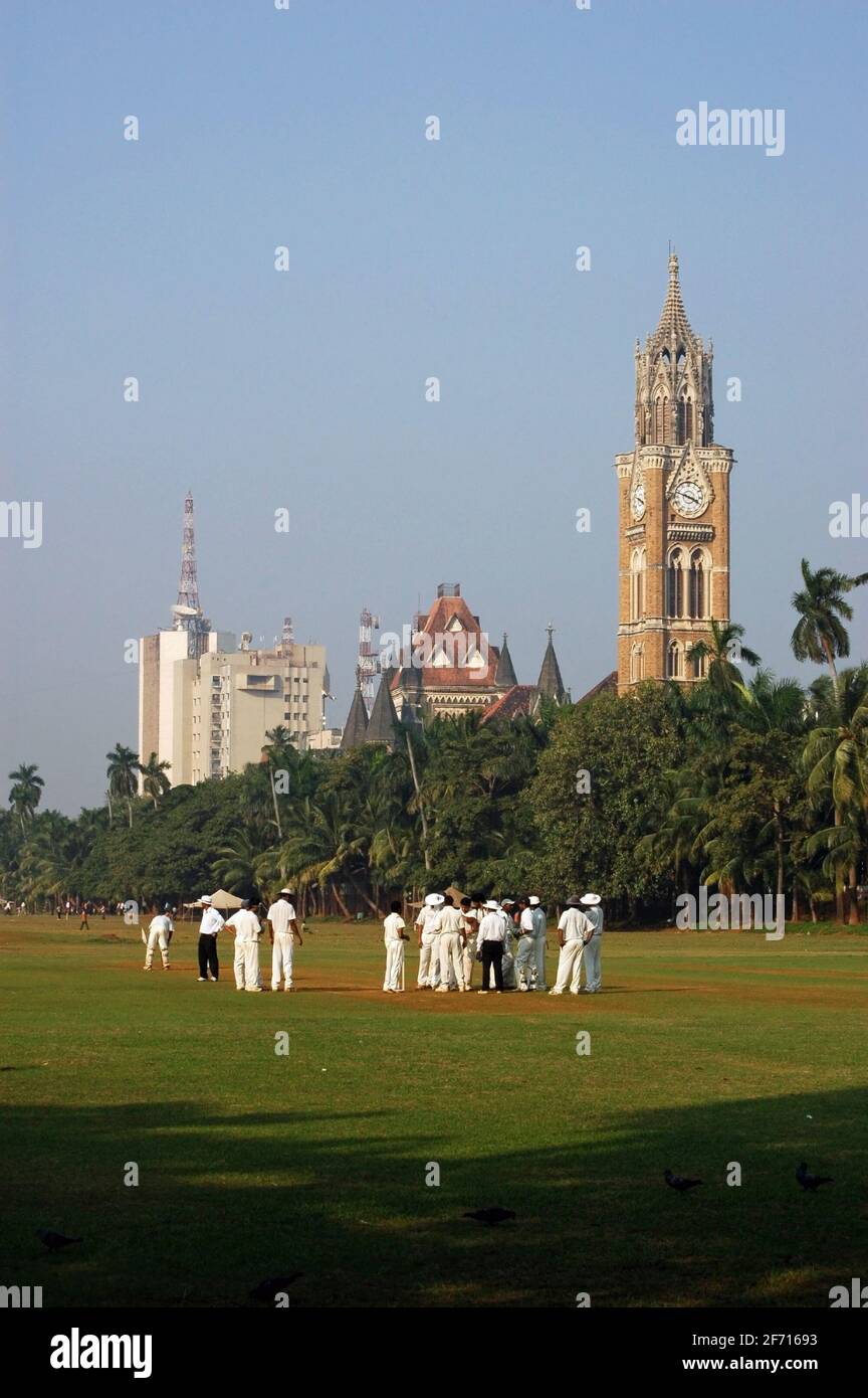 Mumbai, India - November 25, 2009: Players and umpires at a cricket match on the Maidan Oval in the middle of the city of Mumbai, India on a sunny aft Stock Photo