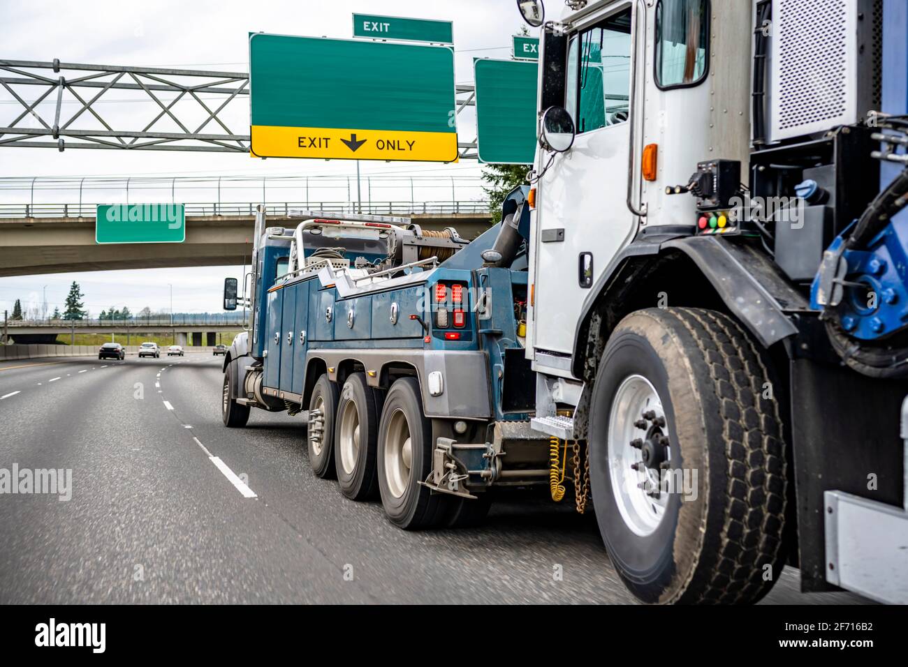 Blue Big rig industrial powerful tow semi truck towing broken semi
