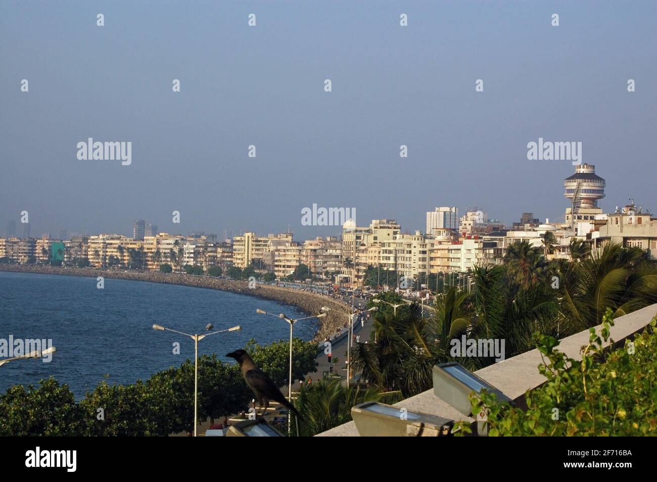A view looking north along Marine Drive and Back Bay in the city of Mumbai (formerly Bombay) with the Indian Ocean lapping against the beach. Stock Photo