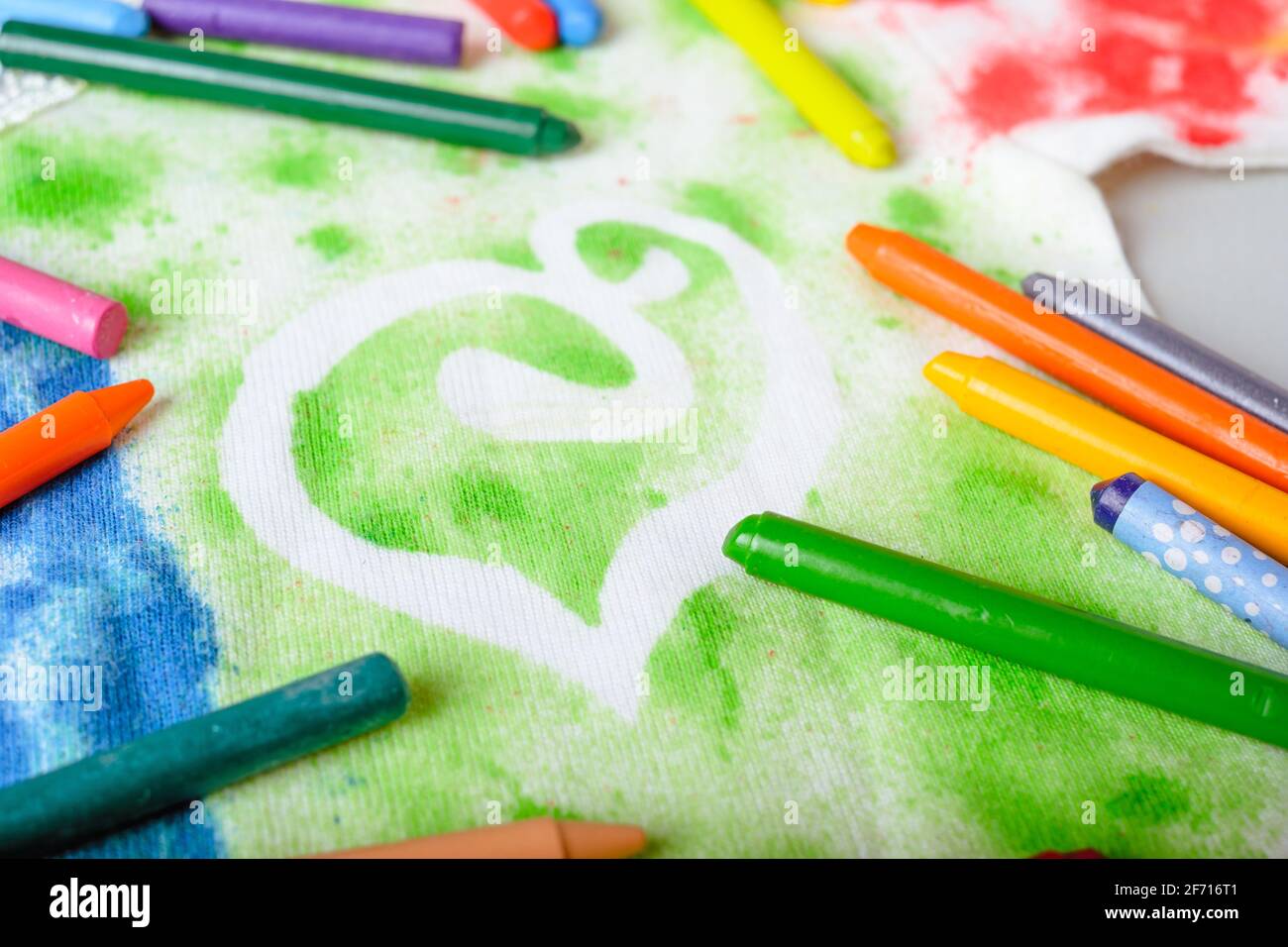 dirty stains from colored pencils on white clothes. Cleaning concept