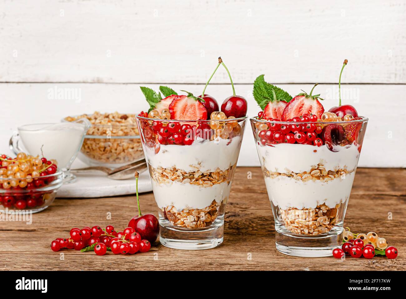 Granola yogurt parfait with fresh berries on wooden background. Copy space Stock Photo