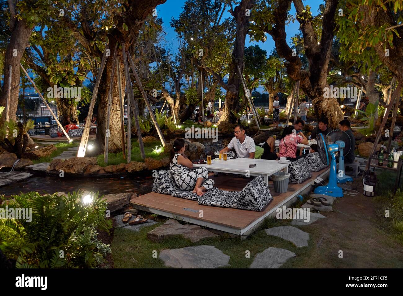 Thailand people eating outside in a quasi jungle setting at a Thai rural restaurant. Southeast Asia Stock Photo