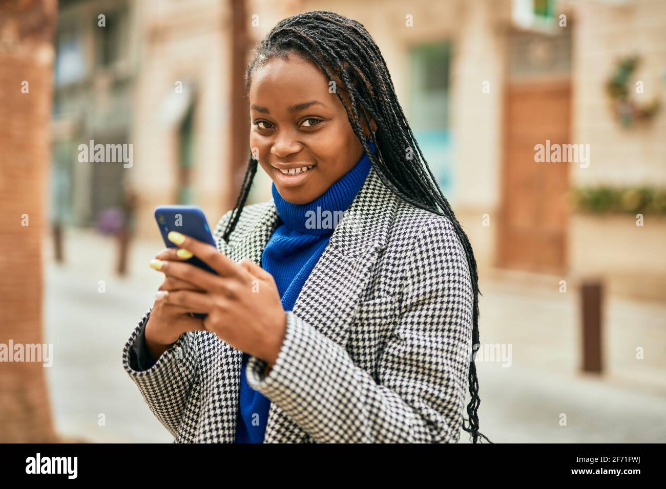 Young african american businesswoman smiling happy using smartphone at ...