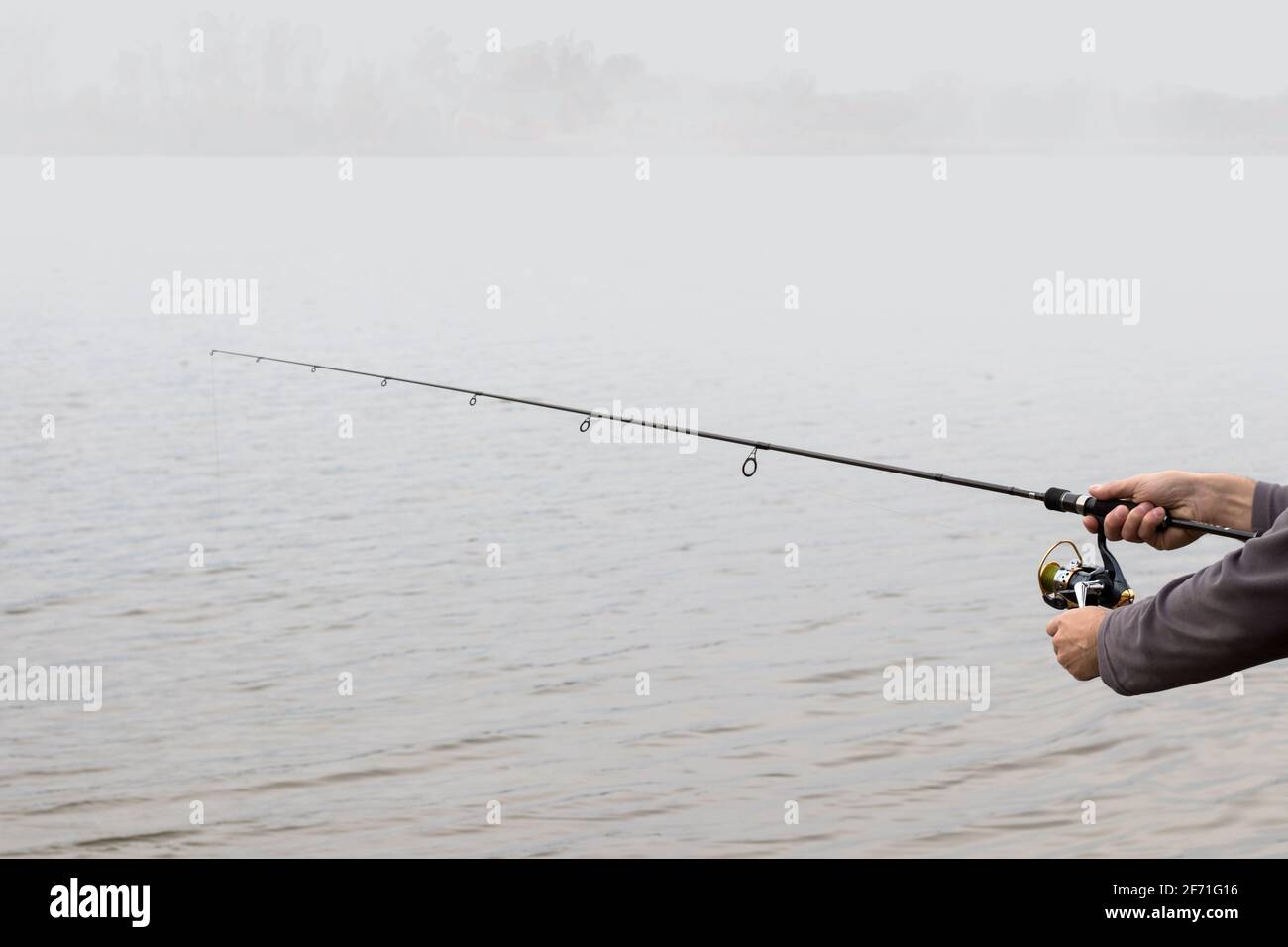 Hands holding a fishing rod hi-res stock photography and images - Alamy