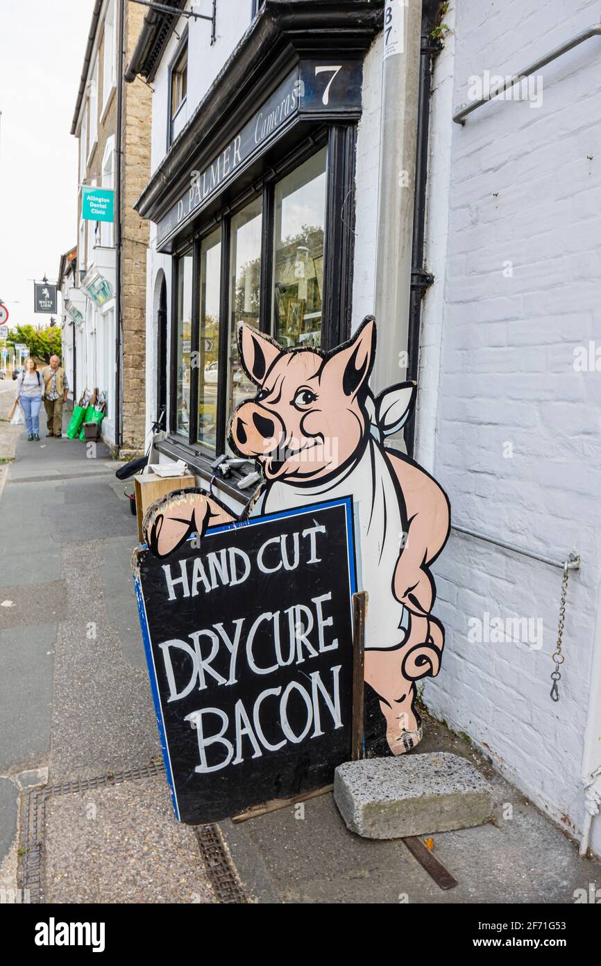 Sign advertising hand cut dry cure bacon aoutside R J Balson & Son, England's oldest family butchers founded in 1515, Bridport, Dorset, SW England Stock Photo