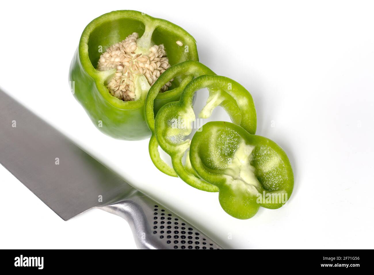 Sliced green bell pepper on white background Stock Photo - Alamy