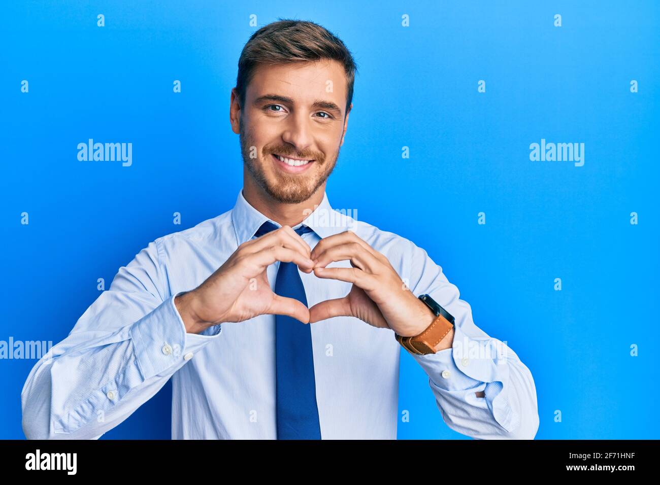 Handsome caucasian man wearing business shirt and tie smiling in love ...