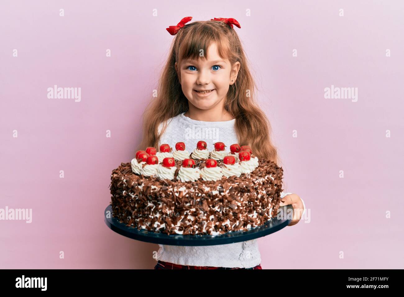 Little caucasian girl kid celebrating birthday holding big ...