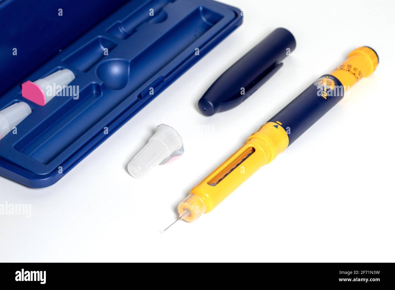 Insulin pen with insulin drop at needle tip isolated on white