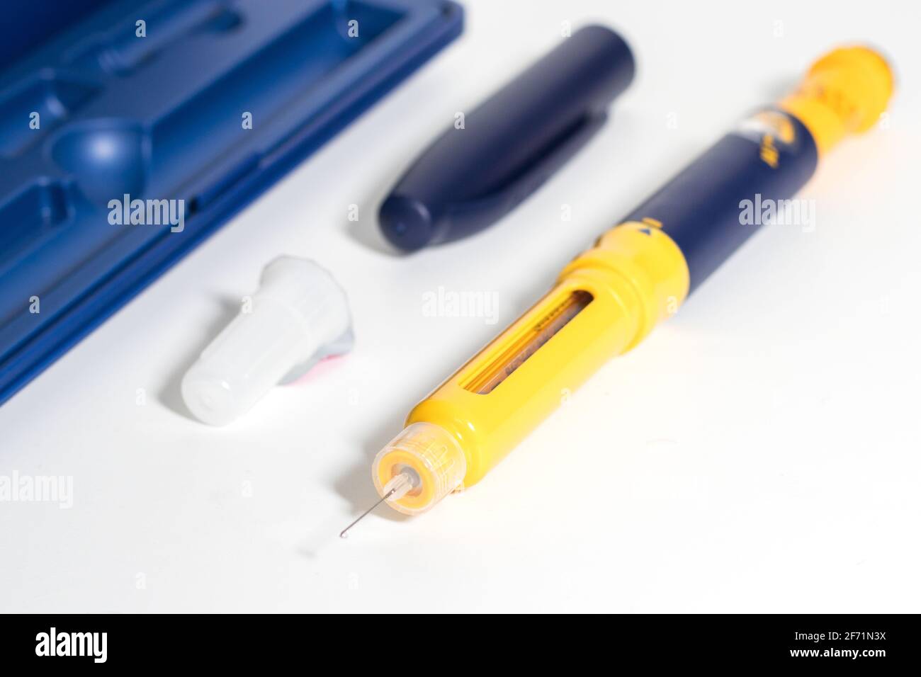 Insulin pen with insulin drop at needle tip isolated on white