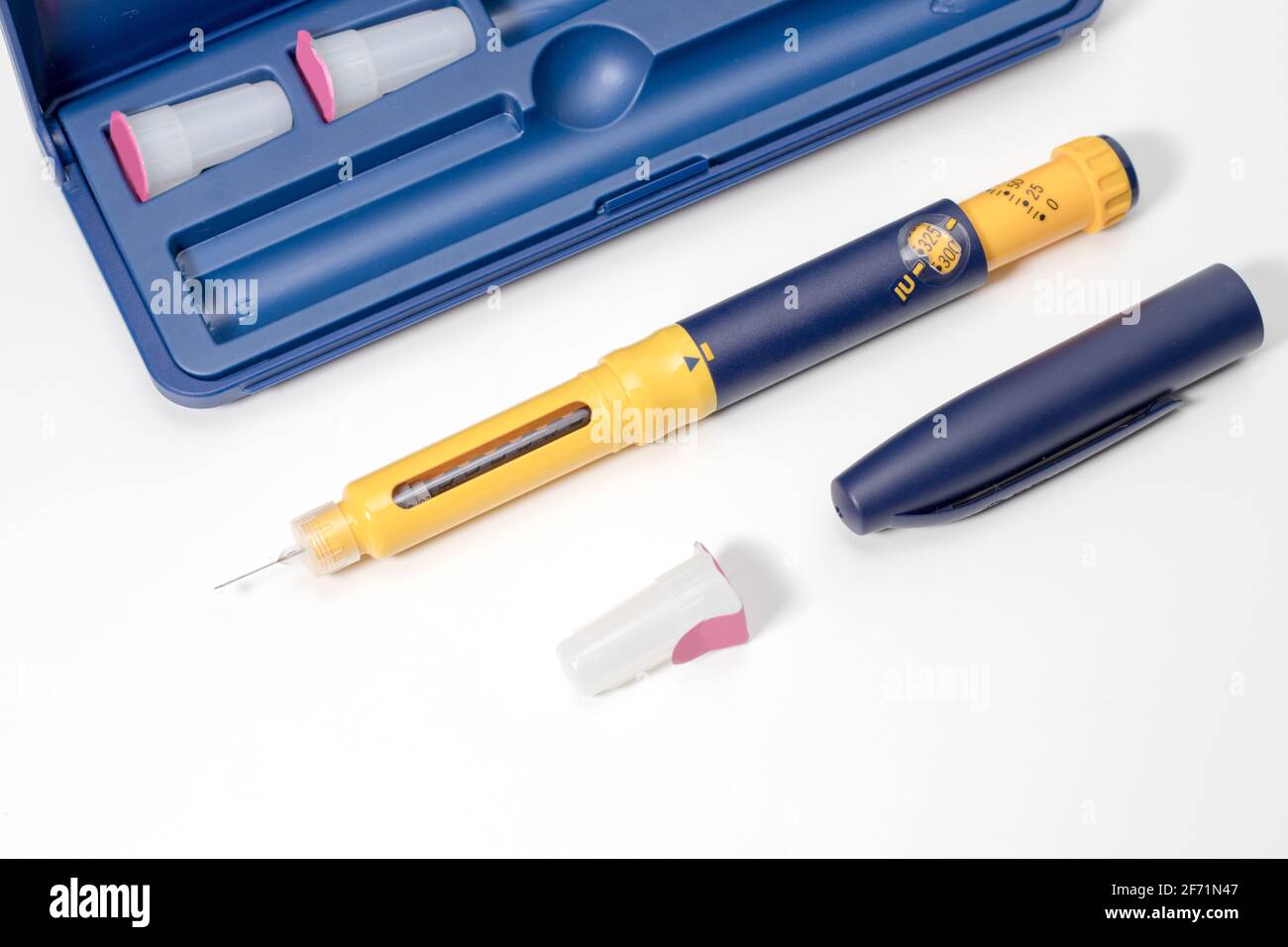 Insulin pen with insulin drop at needle tip isolated on white