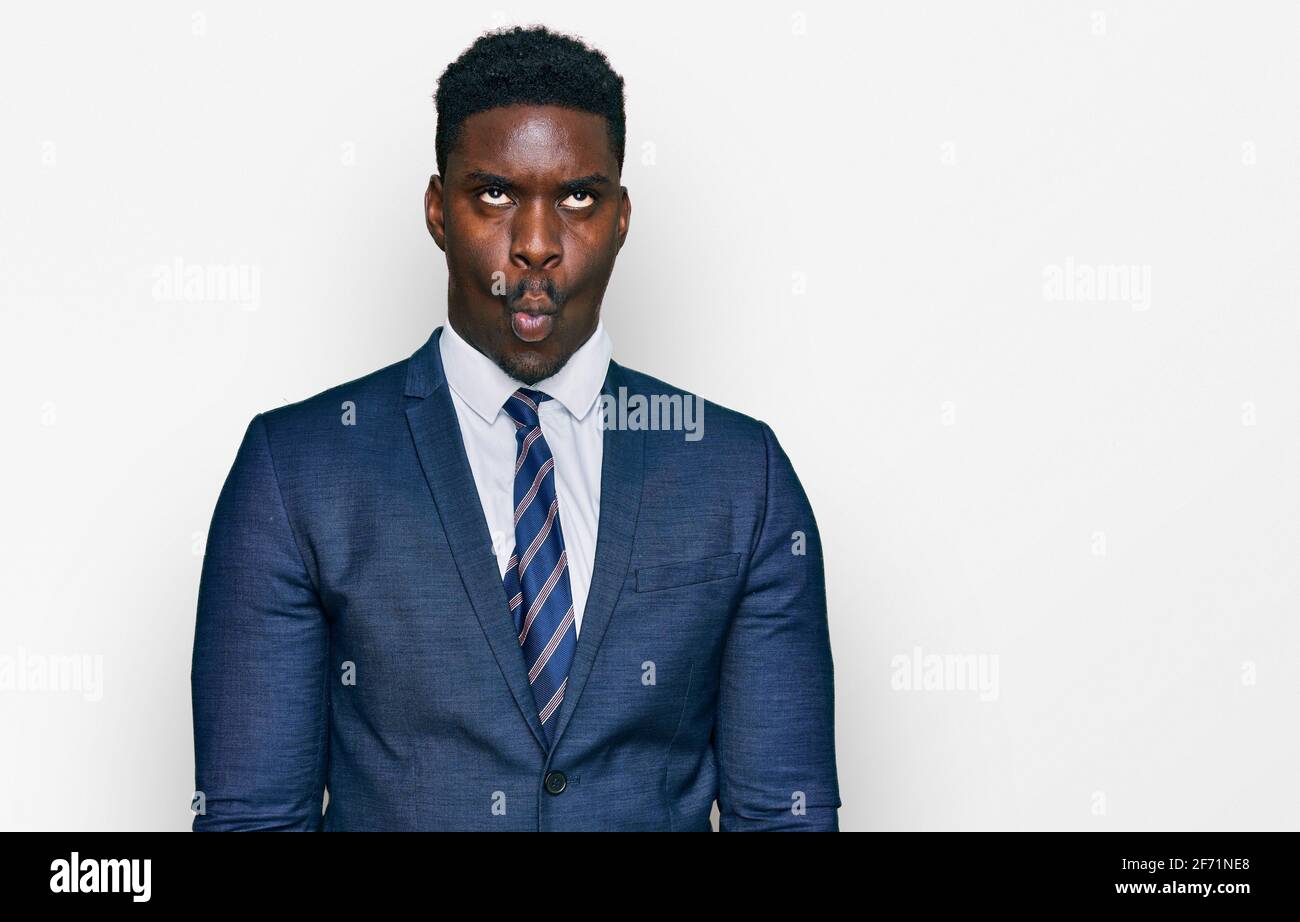Handsome business black man wearing business suit and tie making fish face  with lips, crazy and comical gesture. funny expression Stock Photo - Alamy