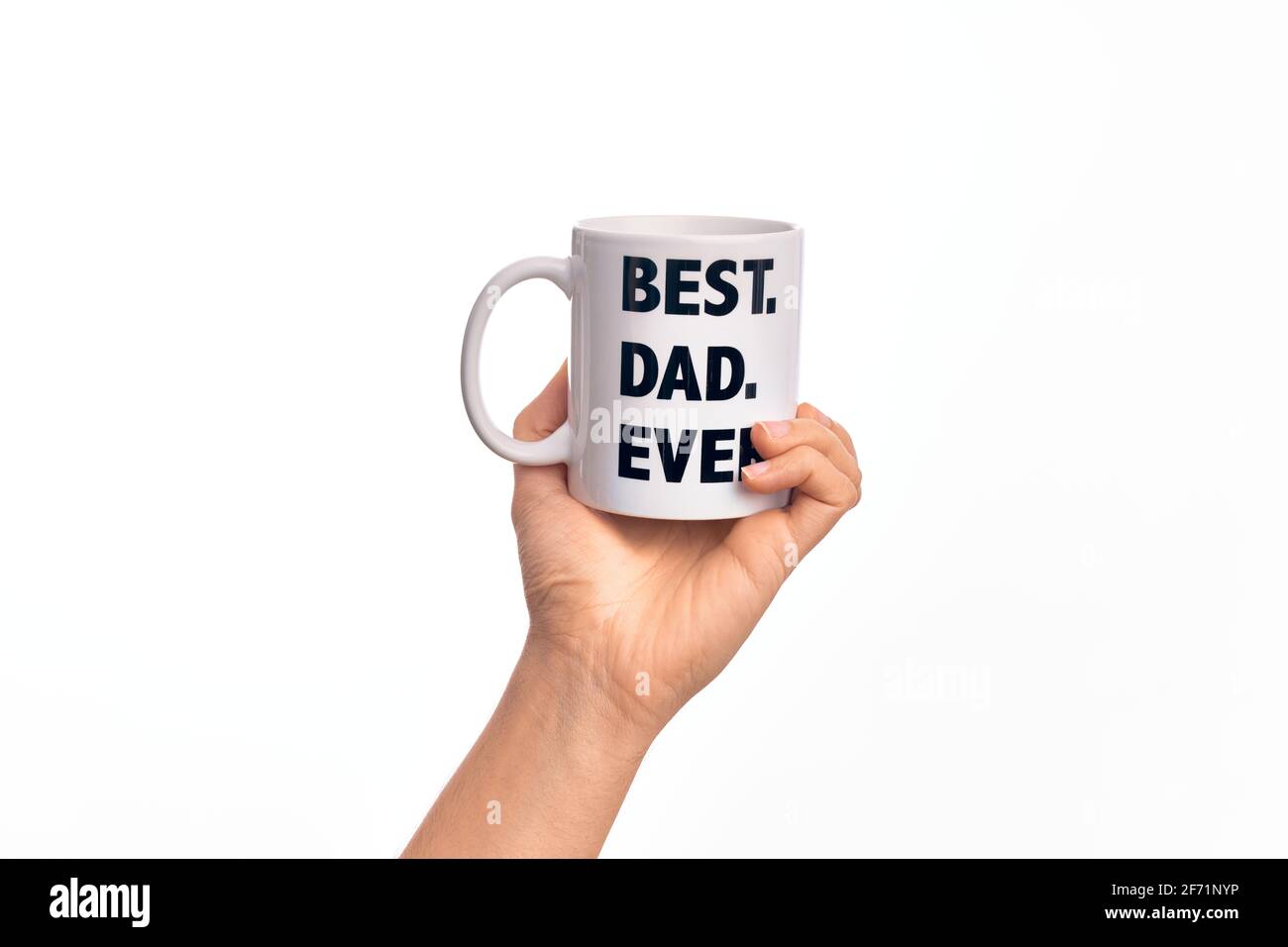 Hand of caucasian young man holding cup of coffee with best dad ever message over isolated white background Stock Photo