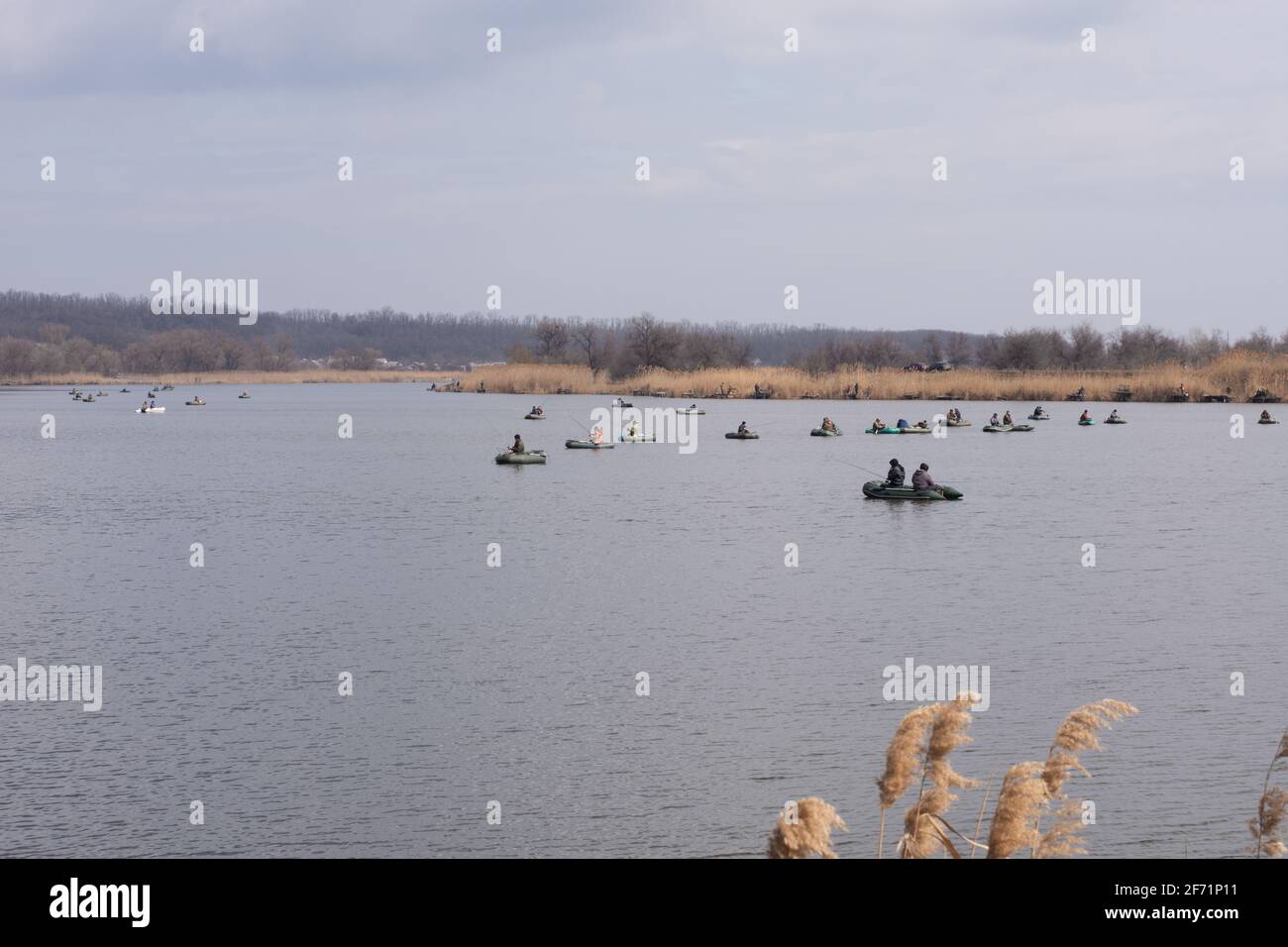 Fishermen on boats catch fish with fishing rods. Stock Photo