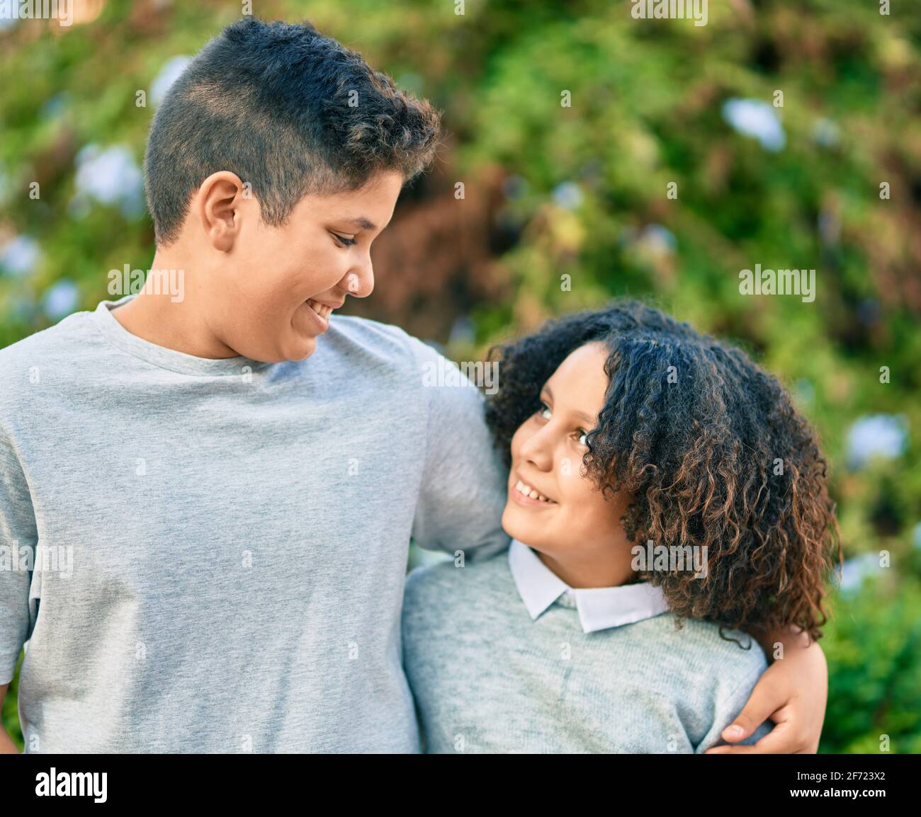Adorable latin brother and sister hugging at the park Stock Photo - Alamy
