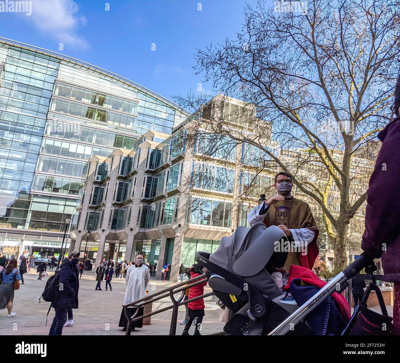 London, UK. 4th April 2021. Congregation exiting Westminster Cathedral, London, following the 10am Easter Sunday Mass celebrated by Roman Catholics. Cathedral chaplains greet and bless parishioners. Stock Photo