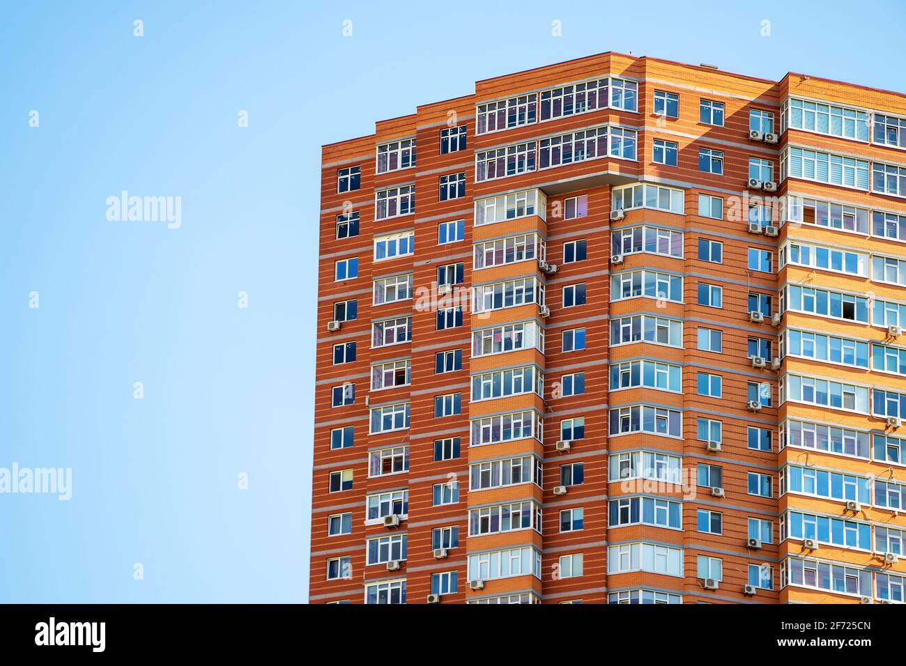 Brick building with windows on sky background. Stock Photo