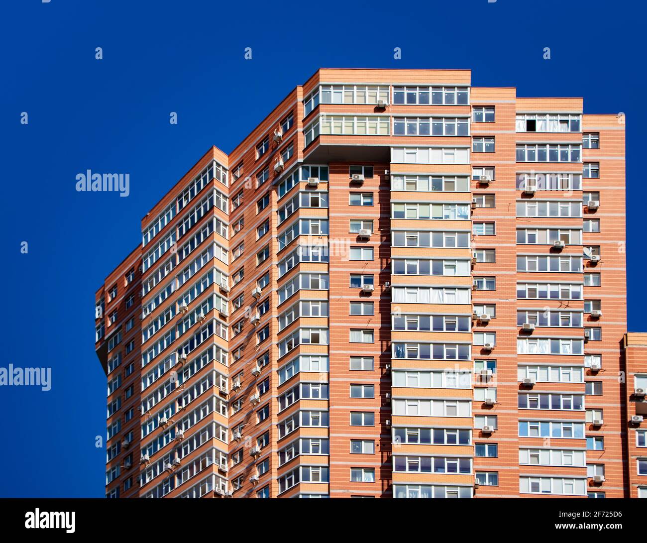 Brick building with windows on sky background. Stock Photo