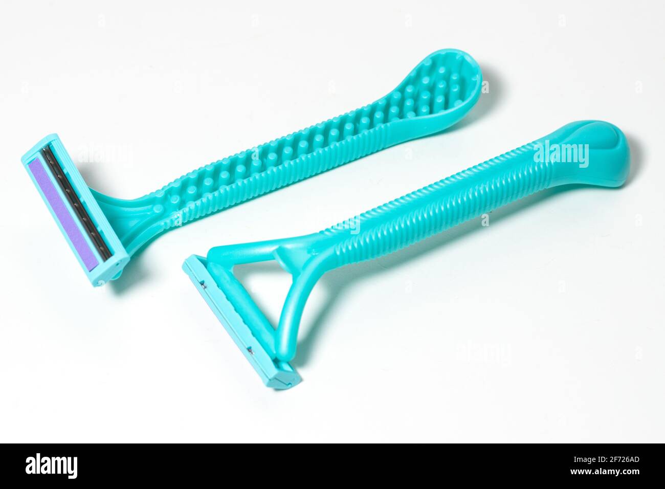 Cyan disposable razors isolated on white background. Stock Photo