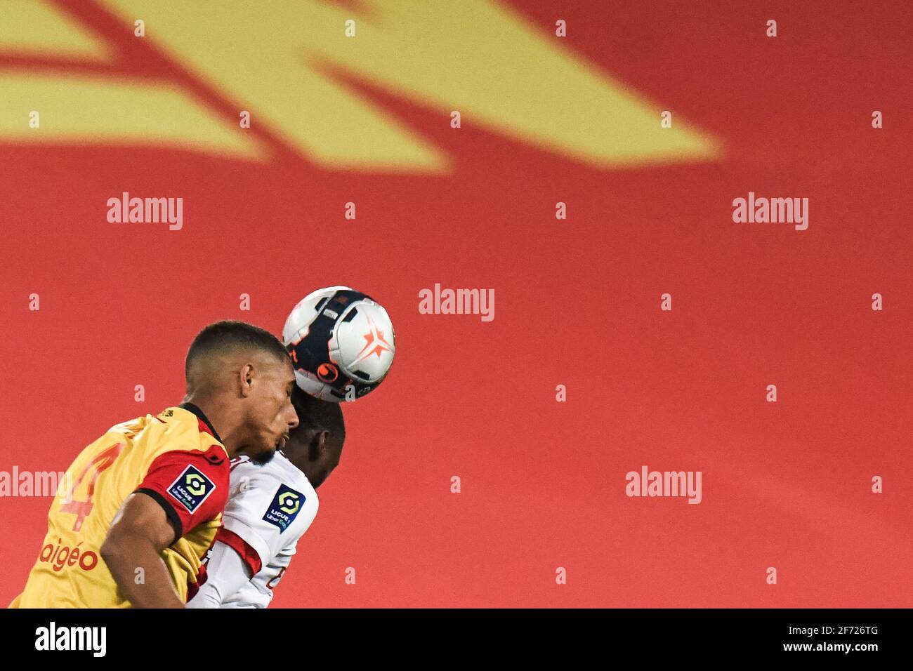 Lens' French defender Loic Bade heads the ball during the Ligue 1 football  match between RC Lens (RCL) and Olympique Lyonnais (OL) at Stade Bollaert  Delelis in Lens, on April 4, 2021.