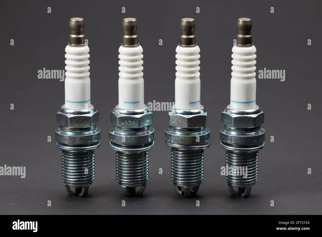Spark plugs on black background. Car and motorcycle part Stock Photo - Alamy