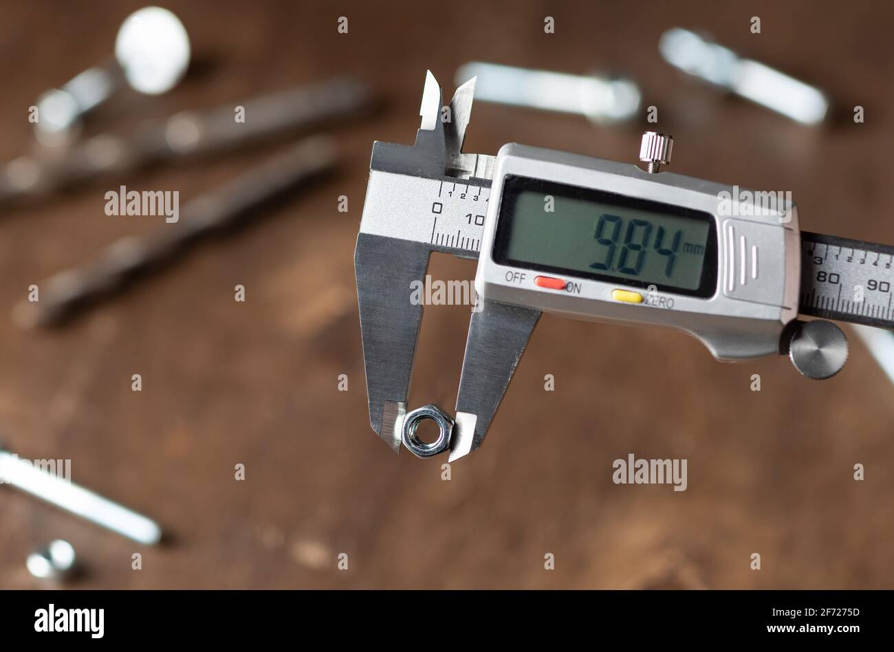 Modern digital caliper on blurred wooden background Stock Photo