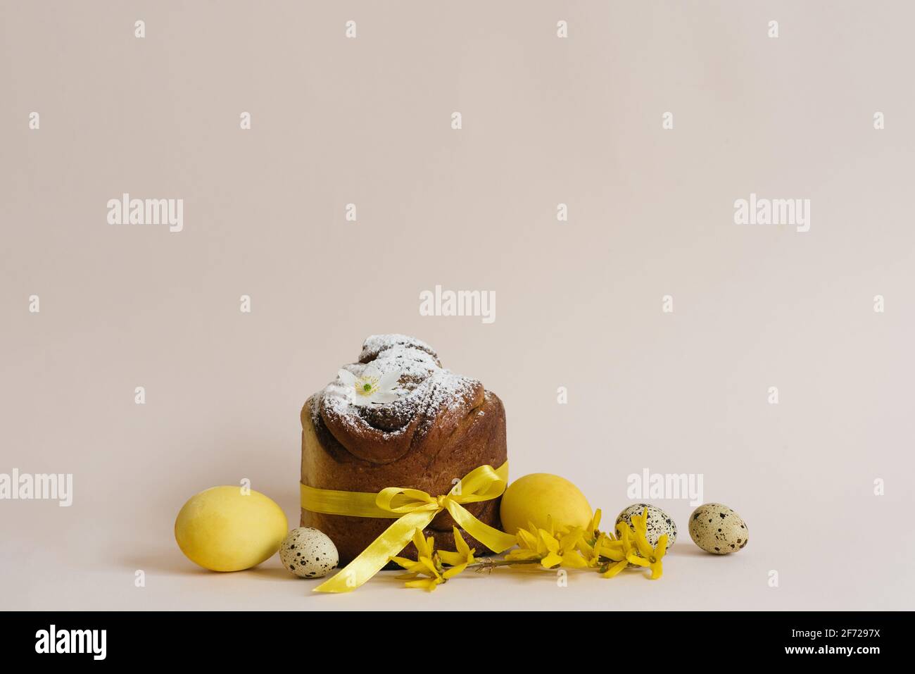 Easter cakes (Orthodox Easter cake), eggs and forsythia branches. The scene of the Easter holiday. Festive composition on the table Stock Photo