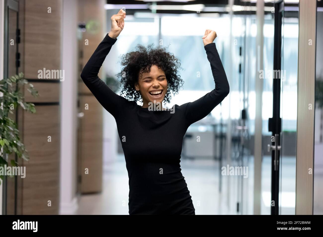 Euphoric black female employee hi-res stock photography and images - Alamy