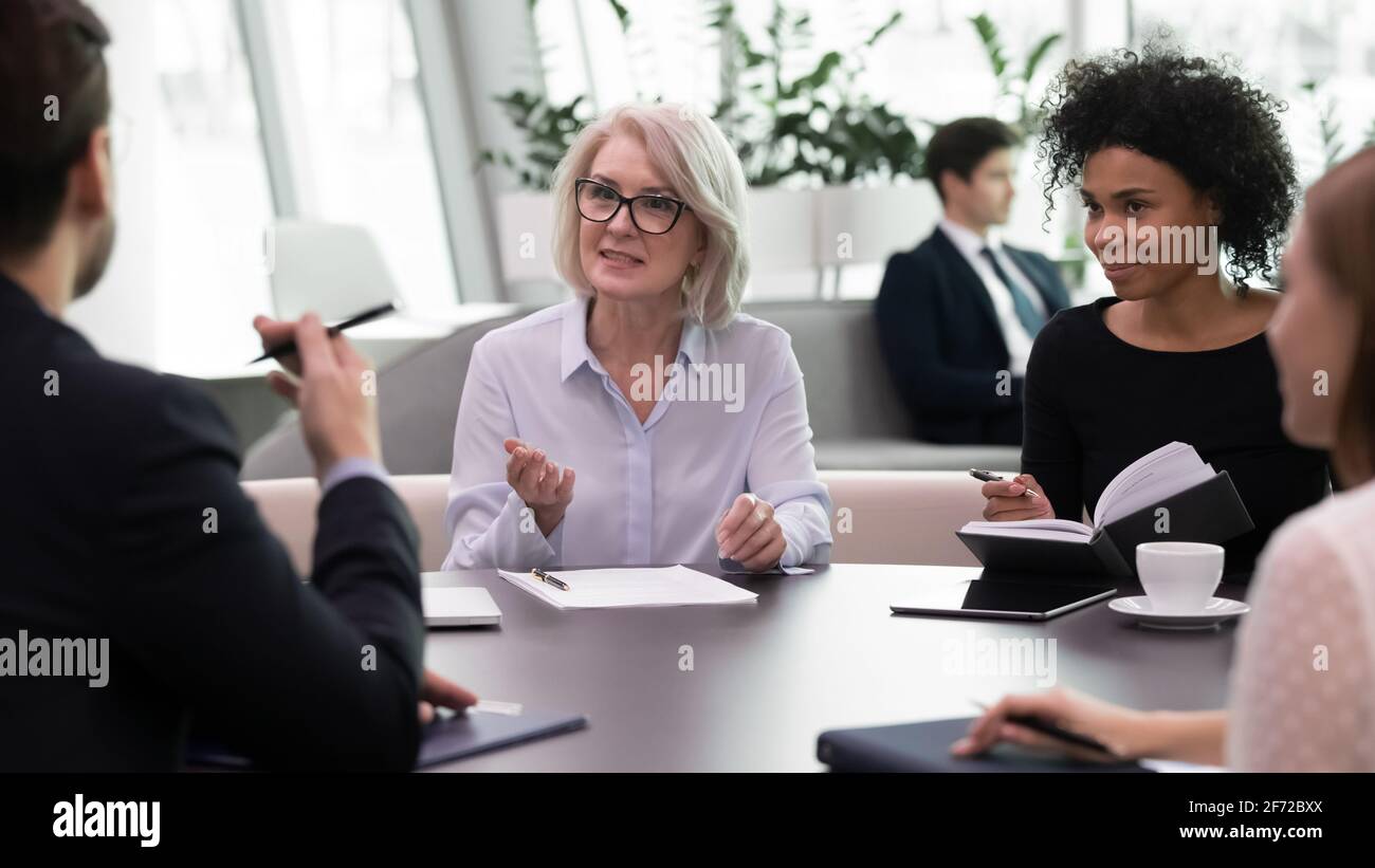 Multiracial colleagues brainstorm at team meeting in office Stock Photo ...