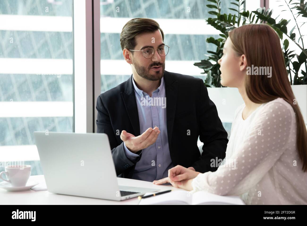 Businesspeople talk brainstorming using laptop at workplace Stock Photo