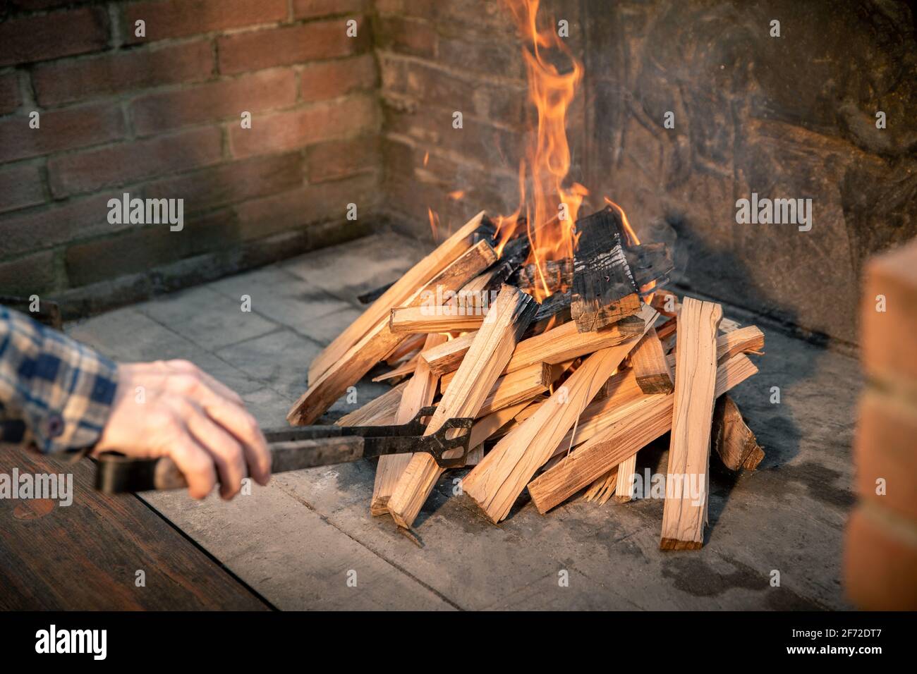 Closeup of pyre of burning wood with flames. Production of charcoal for