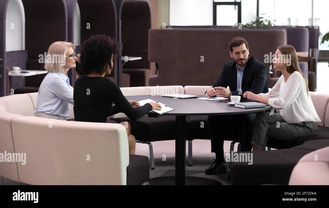 Diverse businesspeople discuss cooperation at casual meeting Stock Photo